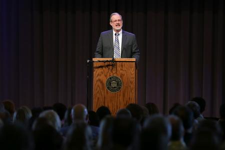 Dan Lancaster, assistant vice president for university ministries, gives the invocation and commission to graduates at the Graduate Commissioning Service.  - Photo by Kristi McMurry Woody