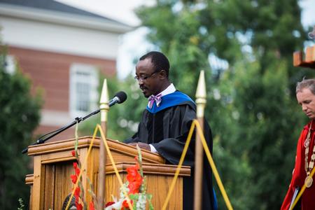 Richard Addo, associate professor of pharmaceutical sciences, gives the invocation at spring commencement services. - Photo by Kristi McMurry Woody