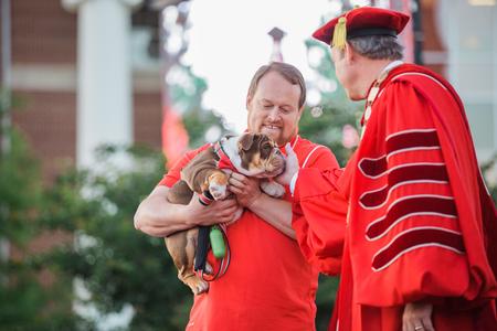 Buster the Bulldog is presented to Dub Oliver, president of the university, as the senior class gift during spring commencement services.  - Photo by Kristi McMurry Woody