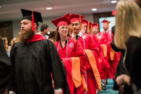 Andrea Baker, doctor of nursing practice graduate, processes with her classmates into Summer Commencement.  - Photo by Kristi McMurry Woody