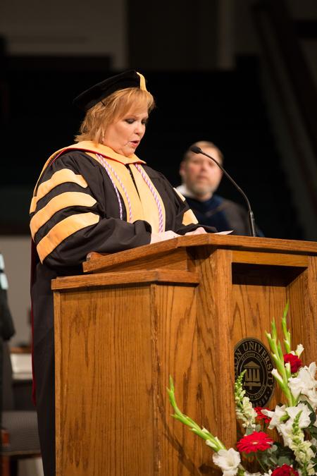 Molly Wright, professor of nursing and chair, reads Luke 5:1-11 during Summer Commencement. - Photo by Kristi McMurry Woody
