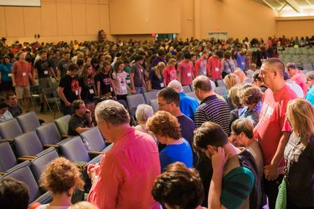 Parents and siblings of new students encircle the students in the chapel for a time of prayer over their first semester of school. - Photo by Kristi McMurry Woody