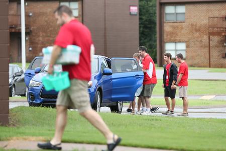Faculty and staff pitch in on new student move-in day to help unload cars and carry belongings.  - Photo by Kristi McMurry Woody