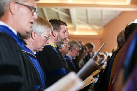 Faculty members sing a congregational hymn during Convocation. - Photo by Kristi McMurry Woody