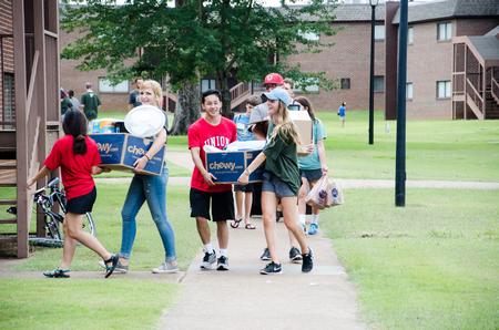 Upperclassmen and faculty help new students move in.  - Photo by Gretchen Foels