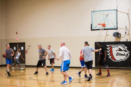 Faculty, staff and students play a game of pickup basketball in the activities center gym. - Photo by Kristi McMurry Woody