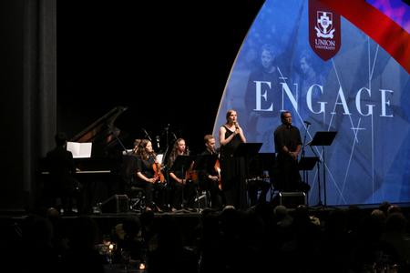 A group of alum, students and staff performs an arrangement by Cody Curtis during the 19th annual Scholarship Banquet.  - Photo by Elizabeth Wilson