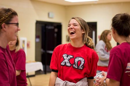 Bekah Guthrie, junior chemistry major, enjoys a laugh at the Make-A-Wish BBQ during Family Weekend.  - Photo by Morgan Morfe