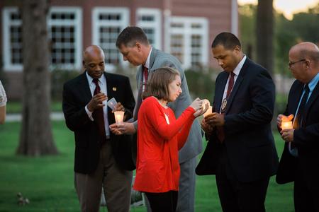 Jackson community leaders light candles to line the Great Lawn for the Remember Me Commemorative Walk for homicide-loss survivors. - Photo by Kristi McMurry Woody