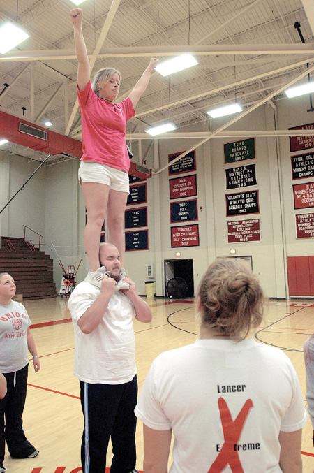 Sophomores Jared Swinney, Biblical studies major, and
Casey Mihalko, undecided major, practice with the cheerleading squad for upcoming games. - Photo by Kristen Hiller