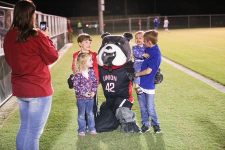 Buster poses for a picture with some soccer fans during a game against Shorter University. - Photo by Kristi McMurry Woody