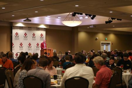 Dub Oliver, president of the university, welcomes Family Weekend guests to the president's brunch in the Grant Events Center. - Photo by Kristi McMurry Woody