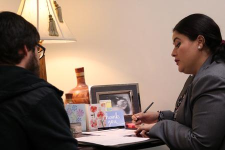 During Vocatio Center's walk-in monday, Esperanza Gonzalez, associate director, assists a student with his resumé in preparation for graduation in the spring.   - Photo by Elizabeth Wilson
