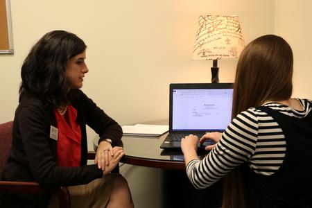 Programming coordinator of Vocatio Center, Breanne Vailes, speaks to a student about the development of her resumé during the Walk-in Monday event. - Photo by Elizabeth Wilson