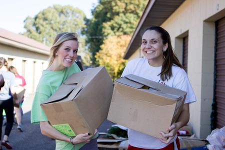 Mikaela Allen (left), sophomore business administration major, and freshman Madeline Fleming smile during their Campus & Community Day project in Humboldt.  - Photo by Morgan Morfe