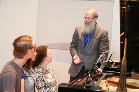 Terry McRoberts, university professor of music, teaches a class of piano students in Hartley Hall. - Photo by Kristi McMurry Woody