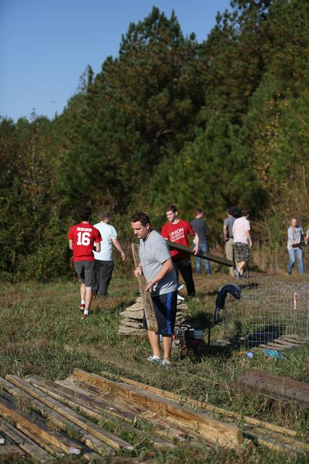 A group of engineering and athletic training students work together on Campus and Community Day to build a mountain bike skills course for the community. - Photo by Kristi McMurry Woody