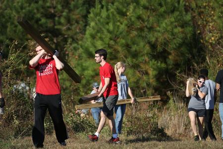 A group of engineering and athletic training students work together on Campus and Community Day to build a mountain bike skills course for the community. - Photo by Kristi McMurry Woody