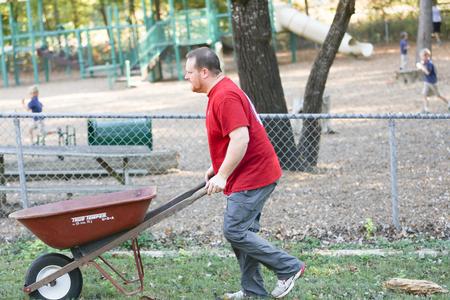 Ken Litscher, director for residence life, helps with a Campus and Community Day project at Augustine School.  - Photo by Kristi McMurry Woody