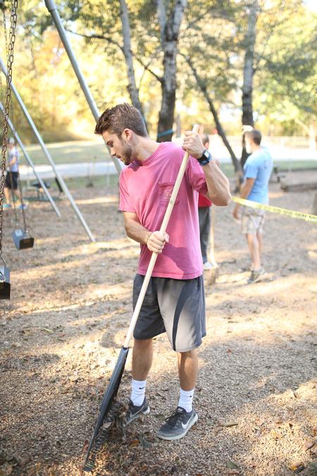 Students work on cleaning up and adding gravel to the playground at Augustine School during Campus and Community Day. - Photo by Kristi McMurry Woody