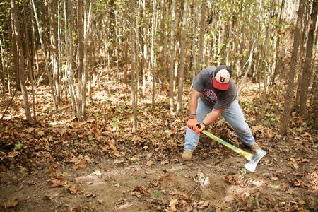 Jonathan Allen, assistant professor of athletic training, helps clear a trail during Campus and Community. - Photo by Kristi McMurry Woody