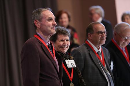 Members of the class of 1967 gather in front of the stage after receiving their 50 year reunion medallions during homecoming chapel. - Photo by Kristi McMurry Woody