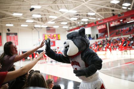 Buster the Bulldog high-fives students during the homecoming basketball game. - Photo by Kristi McMurry Woody