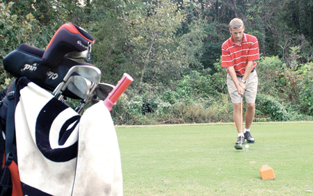 Freshman Gary Glapa concentrated on driving the ball at the Hidden Valley Golf Club. Glapa was preparing for the tournament Oct. 1 at Delta State Univ. in Cleveland, Miss. - Photo by Kristen Nicole Sayres