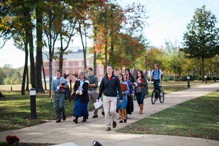 Stephen Hauss, enrollment counselor, leads guests on a tour of campus during Day at the U.  - Photo by Kristi McMurry Woody