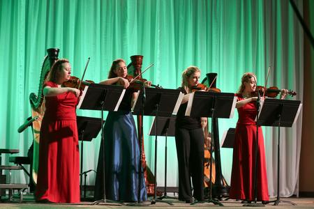 Students perform a violin and harp piece together during the annual Christmas concert, A Union Christmas. - Photo by Kristi McMurry Woody