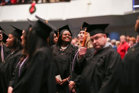 Graduates look around for friends and family at the beginning of fall commencement.  - Photo by Kristi McMurry Woody