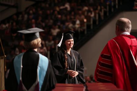 Bryanna England, psychology and theatre graduate, receives her diploma from Dub Oliver, president of the university during fall commencement.  - Photo by Kristi McMurry Woody
