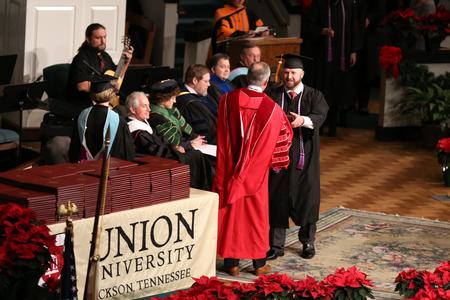 Toby Brown, nursing graduate, walks across the stage to receive his diploma during fall commencement.  - Photo by Kristi McMurry Woody