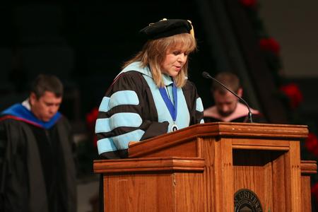 Beverly Absher, chair of the department of continuing studies, gives the invocation during fall commencement.  - Photo by Kristi McMurry Woody