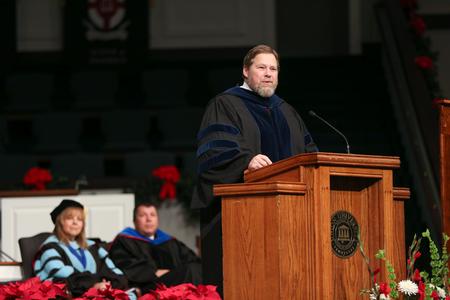 Ben Mitchell, provost, delivers the commencement address during graduation.  - Photo by Kristi McMurry Woody
