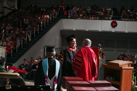 Sarah Elizabeth Huffstetler, MSN graduate, receives her diploma from Dub Oliver, president of the university, during fall commencement.  - Photo by Kristi McMurry Woody