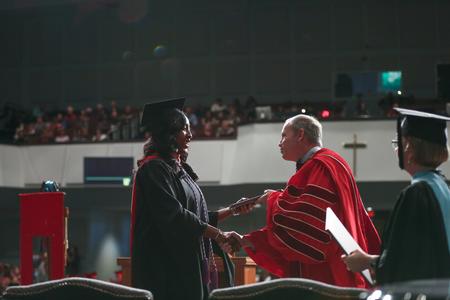 Monica Richardson, receiving her post-graduate certificate in nursing, shakes hands with Dub Oliver, president of the university, during fall commencement. - Photo by Kristi McMurry Woody
