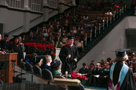 Luka Perkovic, MBA graduate and MBA program coordinator, crosses the stage to receive his diploma during fall commencement. - Photo by Kristi McMurry Woody