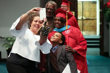 Johna Williams, doctor of education, poses with her family after receiving her degree at fall commencement.  - Photo by Kristi McMurry Woody