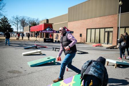 John Windham, director for student financial planning, plays cornhole during the tailgating event before the basketball games against West Georgia.  - Photo by Kristi McMurry Woody