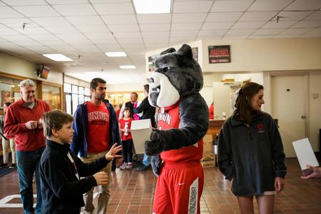 Buster the Bulldog helps hand out bobbleheads before the basketball games. The first 500 fans into the game received a free bobblehead of Buster.  - Photo by Kristi McMurry Woody