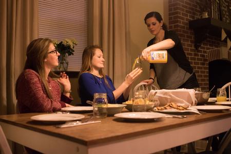 Kayla Corona, the women's quads resident director, serves students during the SAC event, Be Our Guest.  - Photo by Morgan Morfe