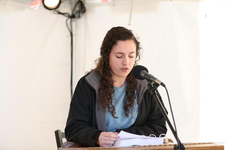 Aubrie Brister, freshman nursing major, reads from Proverbs during the scripture reading marathon. - Photo by Kristi McMurry Woody