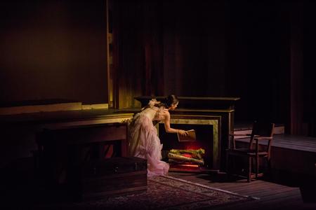 Ashley Greene, sophomore, plays Amy March as she burns her sister's manuscript in the musical version of Little Women. - Photo by Kristi McMurry Woody