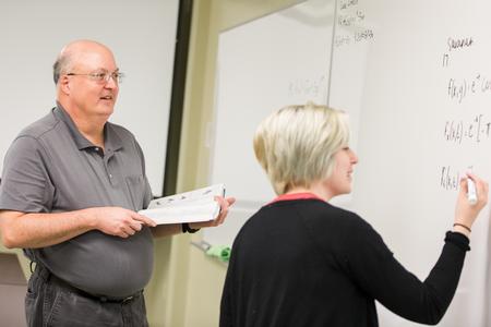 Bryan Dawson, professor of mathematics, works through math problems with Savanah Philip, sophomore mathematics major, during class.  - Photo by Kristi McMurry Woody