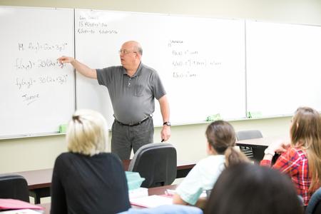 Bryan Dawson, professor of mathematics, works through math problems with his students. - Photo by Kristi McMurry Woody