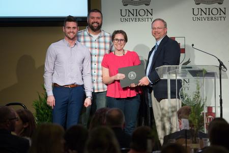 Micah and Emily Whitaker, alums, accept a scholarship from the Union Auxiliary during the banquet. The Whitakers will choose an incoming new student to receive this scholarship in the fall of 2018. - Photo by Kristi McMurry Woody