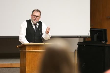 Gavin Richardson, professor of English, introduces the three professors giving a reading in Harvey Auditorium. - Photo by Kristi McMurry Woody