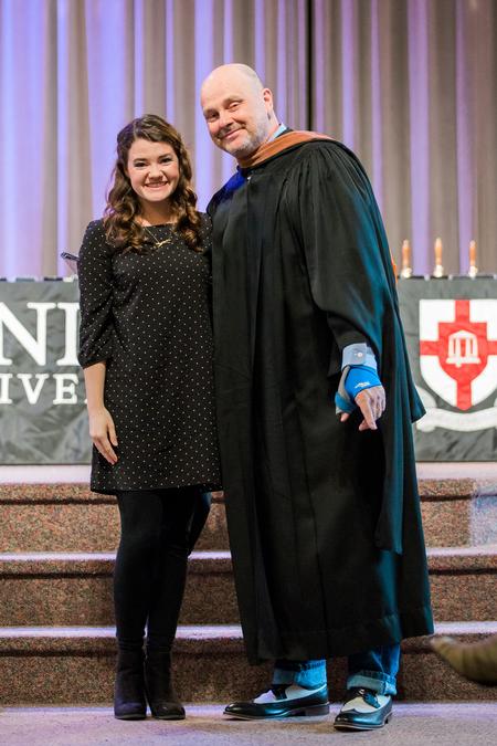Mary Scarlett Greenway, senior art major, accepts her academic excellence award in art from Lee Benson, professor of art and department chair, during Awards Day chapel. - Photo by Kristi McMurry Woody