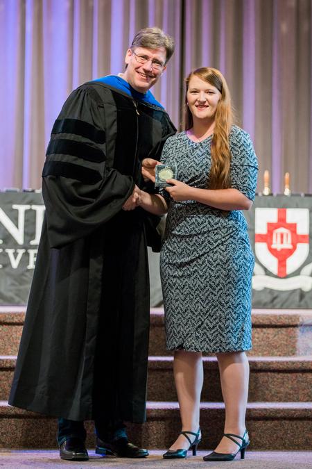Chris Blair, professor of communication arts and coordinator of DMS, recognizes academic excellence medal winner Elizabeth Wilson, senior digital media communications major. - Photo by Kristi McMurry Woody